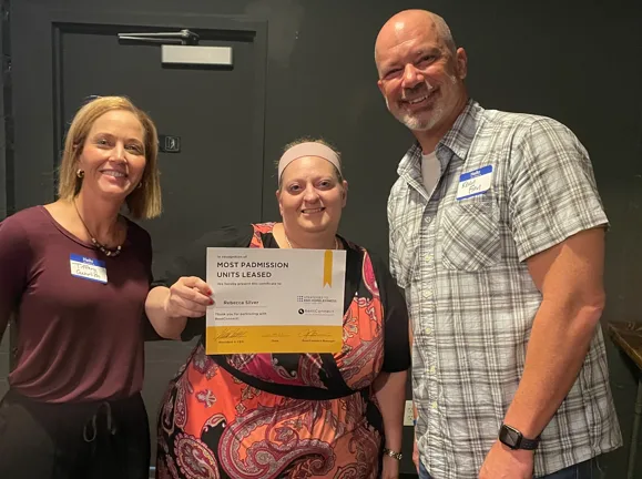 RentConnect staff in Cincinnati presenting a property partner with a certificate for the most units leased through Padmission.